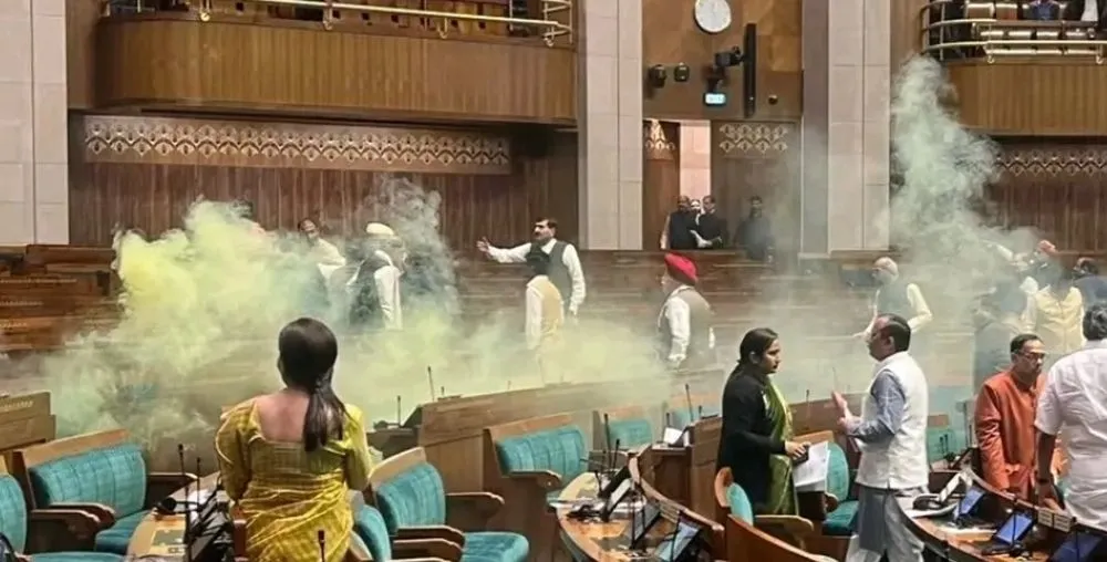 Two people break into a session of the Indian parliament, spraying gas in the hall