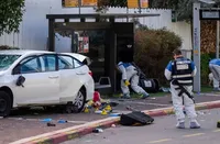 An attack in a Tel Aviv suburb leaves a woman dead and several people injured