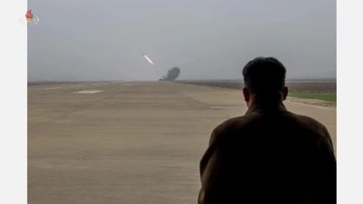 Kim Jong-un watches the test of a new 240mm multiple launch rocket system