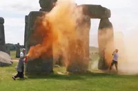 In Britain, two activists sprayed orange paint on Stonehenge