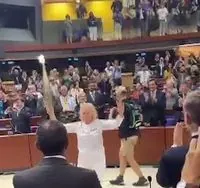 During the PACE meeting, the Olympic flame was brought into the hall