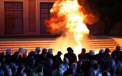 In Albania, demonstrators throw Molotov cocktails at the government building